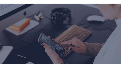 Person at desk using mobile phone