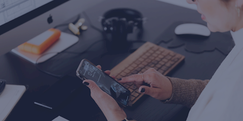 Person at desk using mobile phone